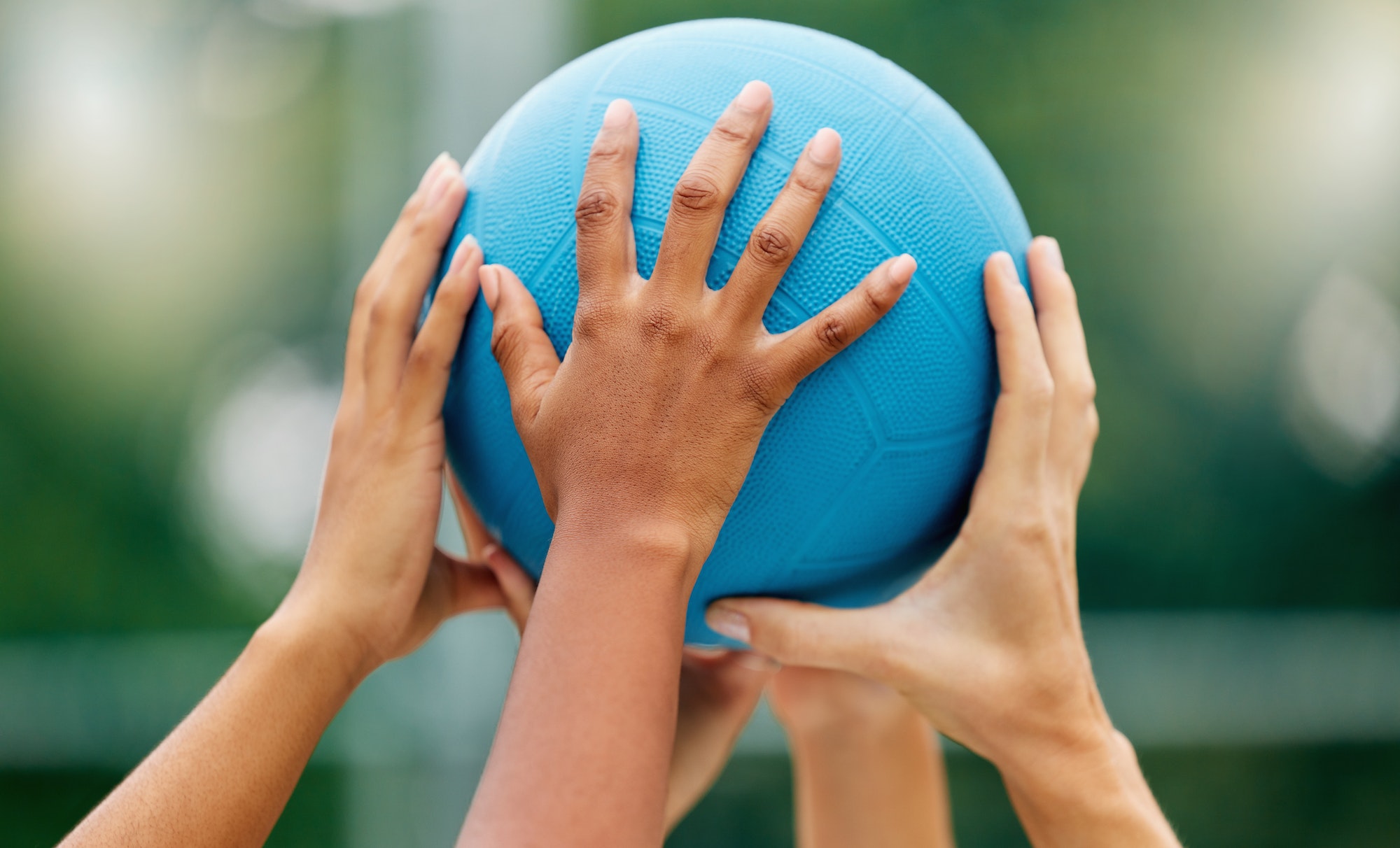 Netball, hands and woman holding a ball during a game for support, teamwork or training together. S